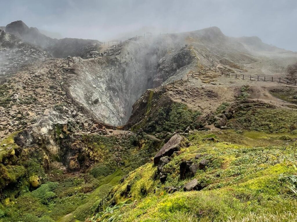 A view of La Soufriere volcano on Bass-Terre, Guadeloupe. The image shows the crater surrounded by clouds, as an example of a volcano formation.